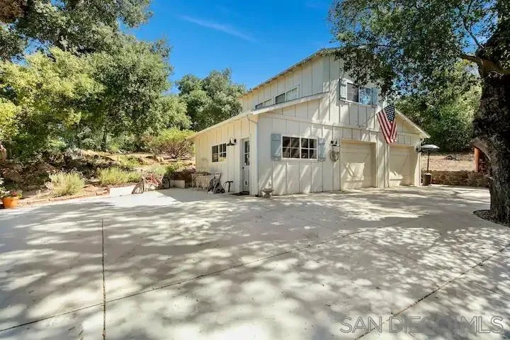 3505 Deer Lake Park Road Julian, CA 92036 - Photo 15 of 46 a view of a white house with a large tree