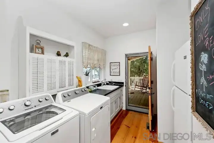 3505 Deer Lake Park Road Julian, CA 92036 - Photo 33 of 46 a view of washer and dryer with kitchen in the background