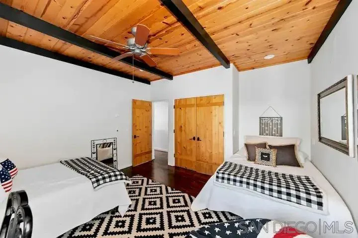 3505 Deer Lake Park Road Julian, CA 92036 - Photo 37 of 46 a bedroom with a bed and wooden floor