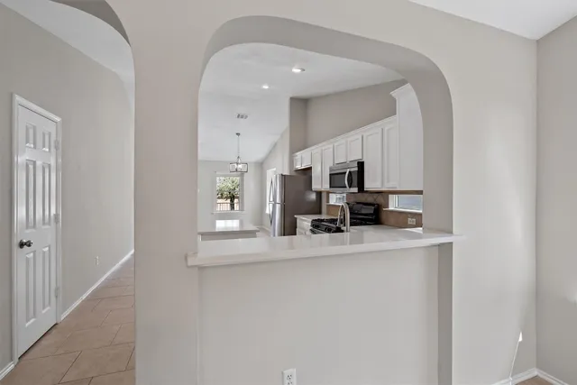 a kitchen with stainless steel appliances a sink and a refrigerator