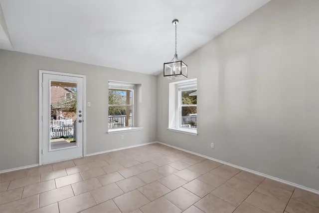 a view of an empty room with windows