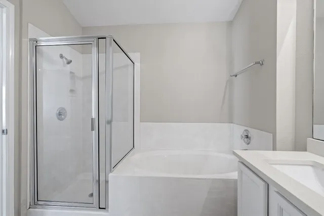 a bathroom with a shower and a glass door