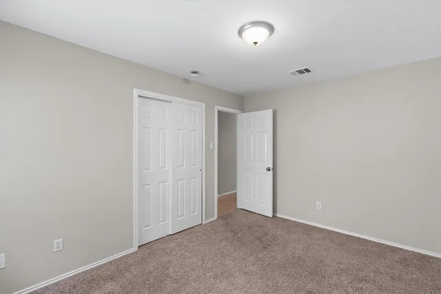 a bathroom with a bathtub shower sink vanity mirror and toilet
