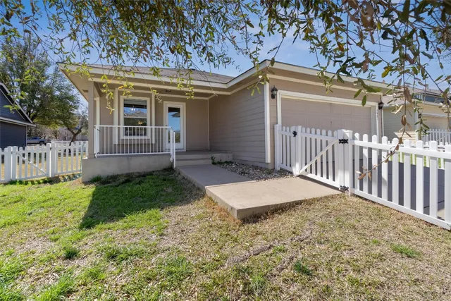 a view of a house with wooden fence