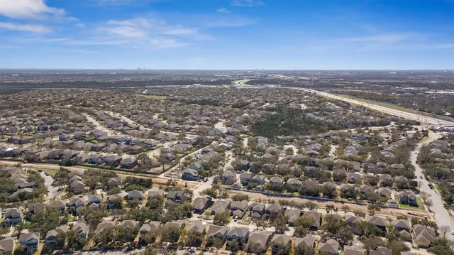 an aerial view of residential houses with city view