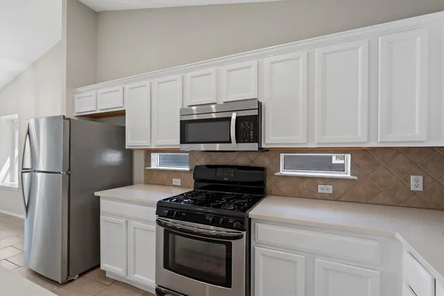a kitchen with a stove microwave and refrigerator