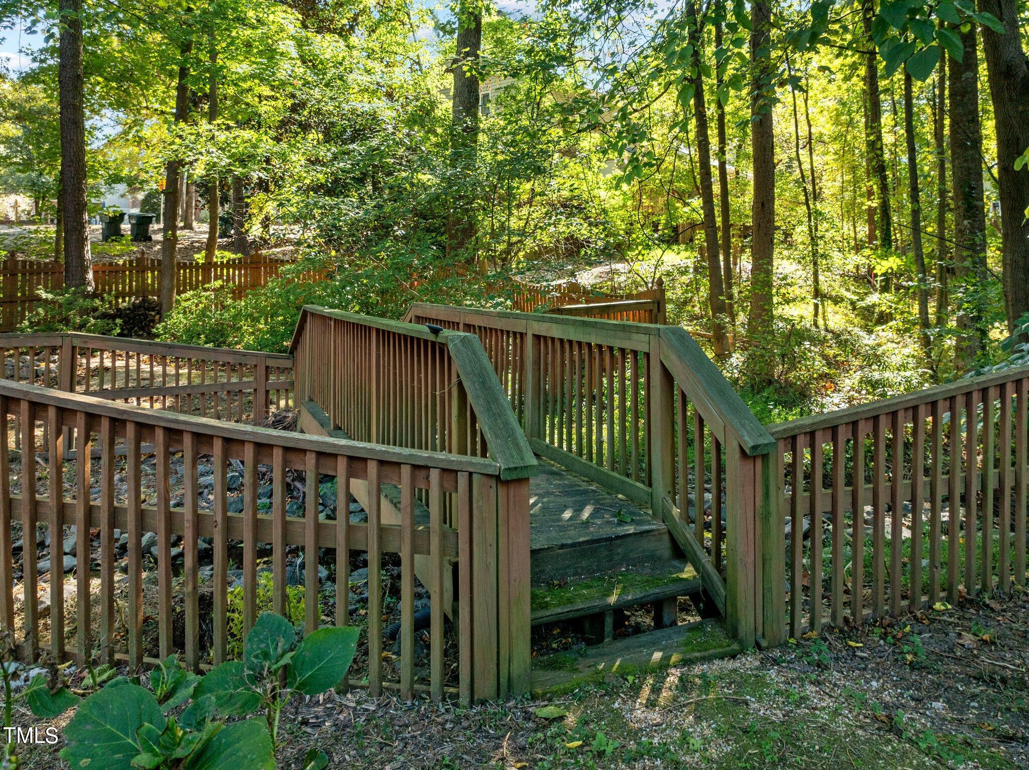 7621 Wilderness Road Raleigh, NC 27613 - Photo 57 of 60 Quaint bridge over creek to fire pit