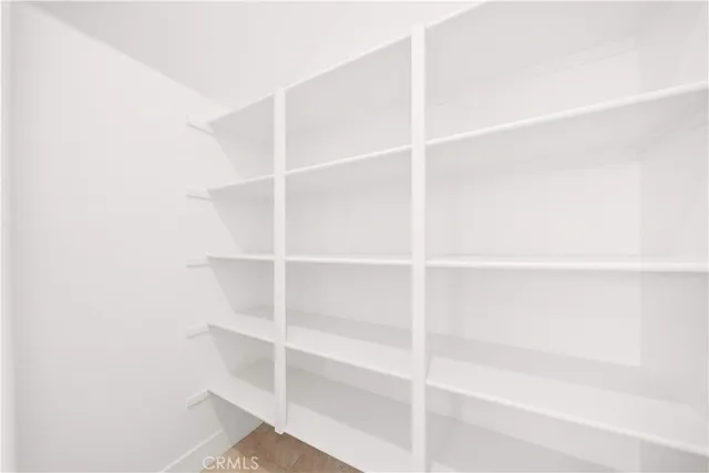 a view of an empty room and wooden floor