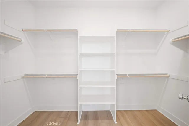 a white toilet sitting next to a white cabinet