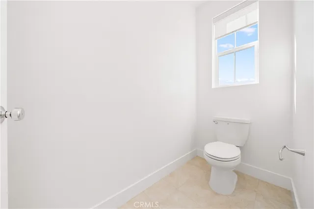 a view of a terrace with lawn chairs