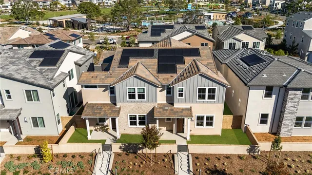 a view of a kitchen with kitchen island a sink wooden floor and a refrigerator
