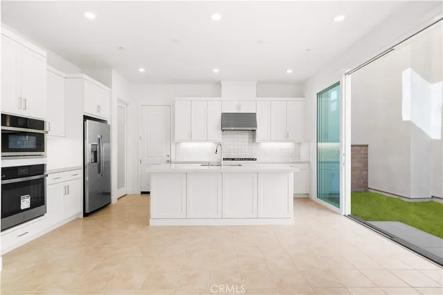 a kitchen with granite countertop a white stove top oven and cabinets