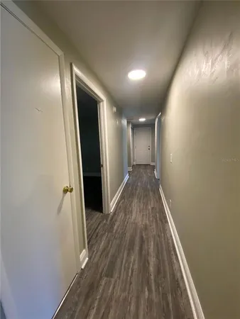 a view of hallway with wooden floor