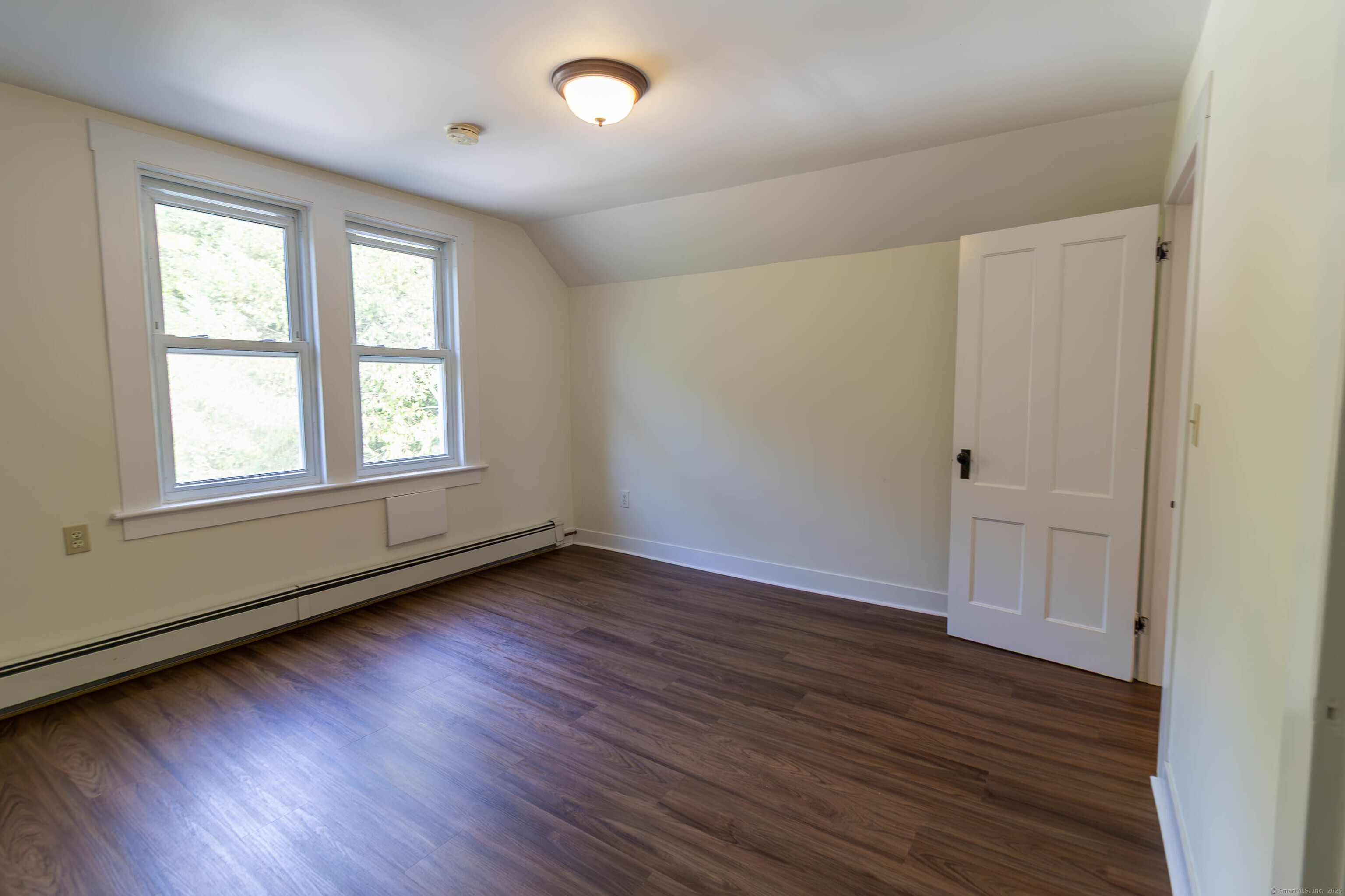 62 Lincoln Avenue Torrington, CT 06790 - Photo 14 of 15 an empty room with wooden floor and windows