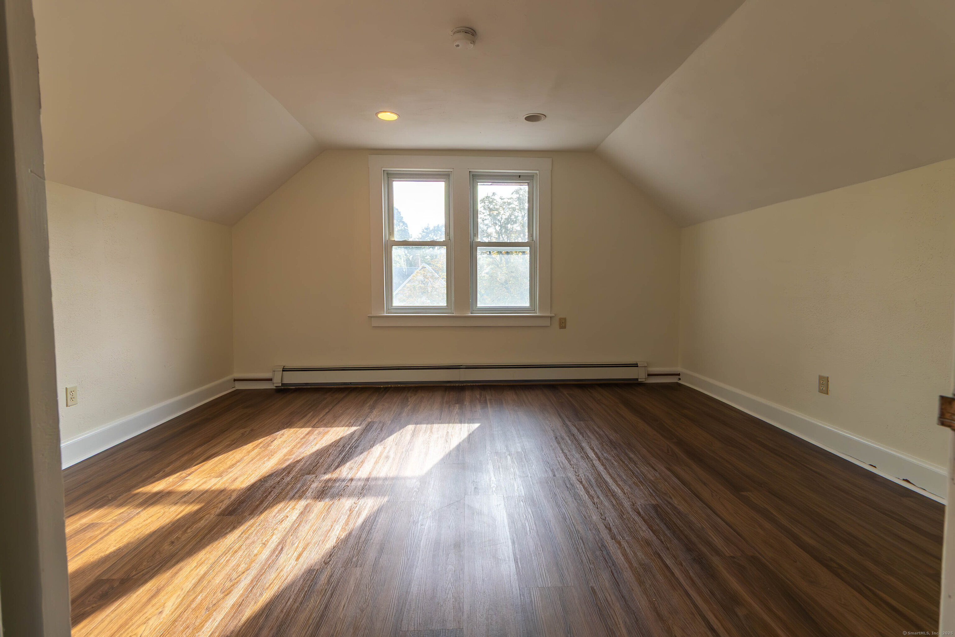 62 Lincoln Avenue Torrington, CT 06790 - Photo 15 of 15 an empty room with wooden floor and windows