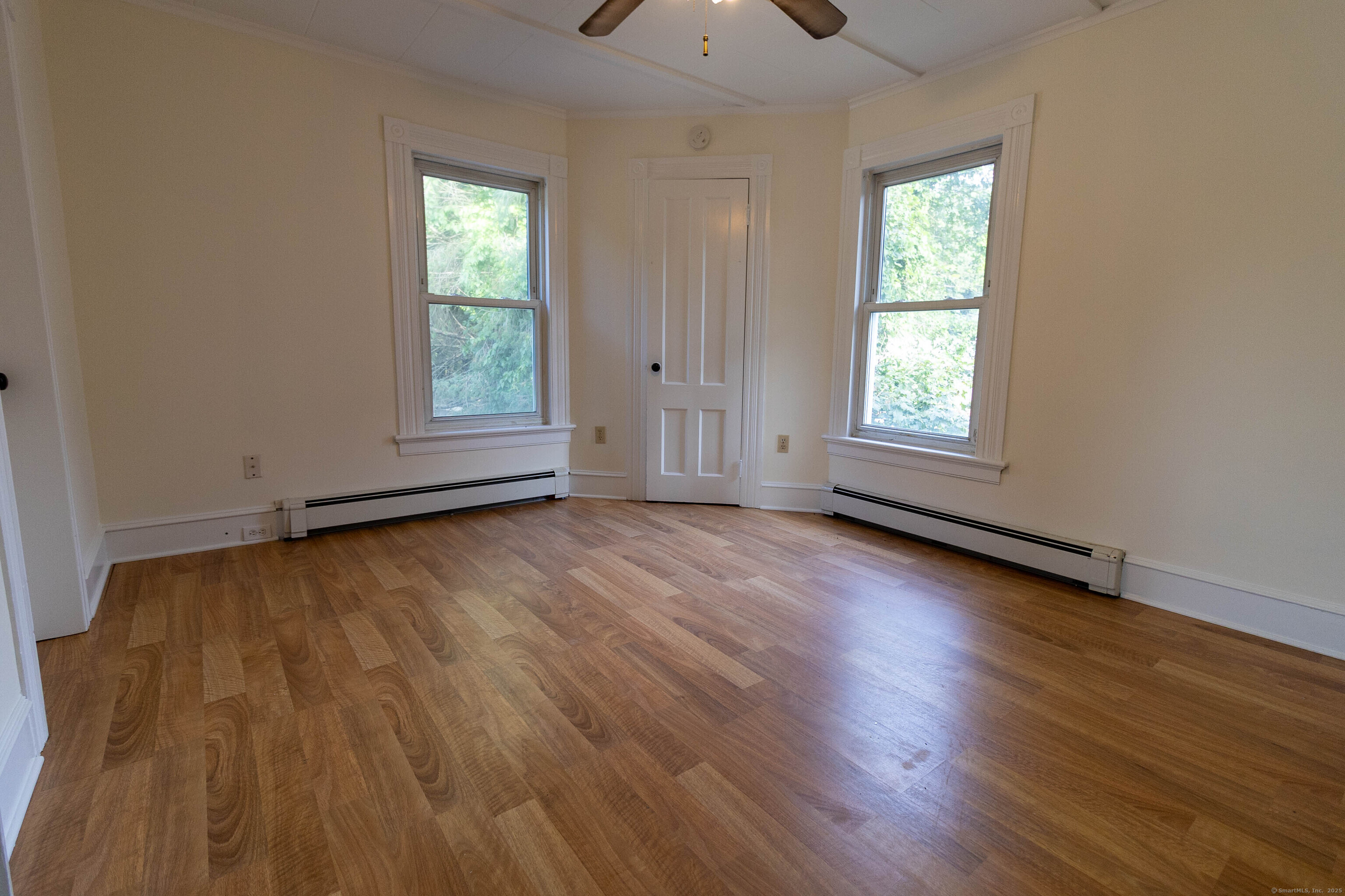62 Lincoln Avenue Torrington, CT 06790 - Photo 2 of 15 an empty room with wooden floor and windows