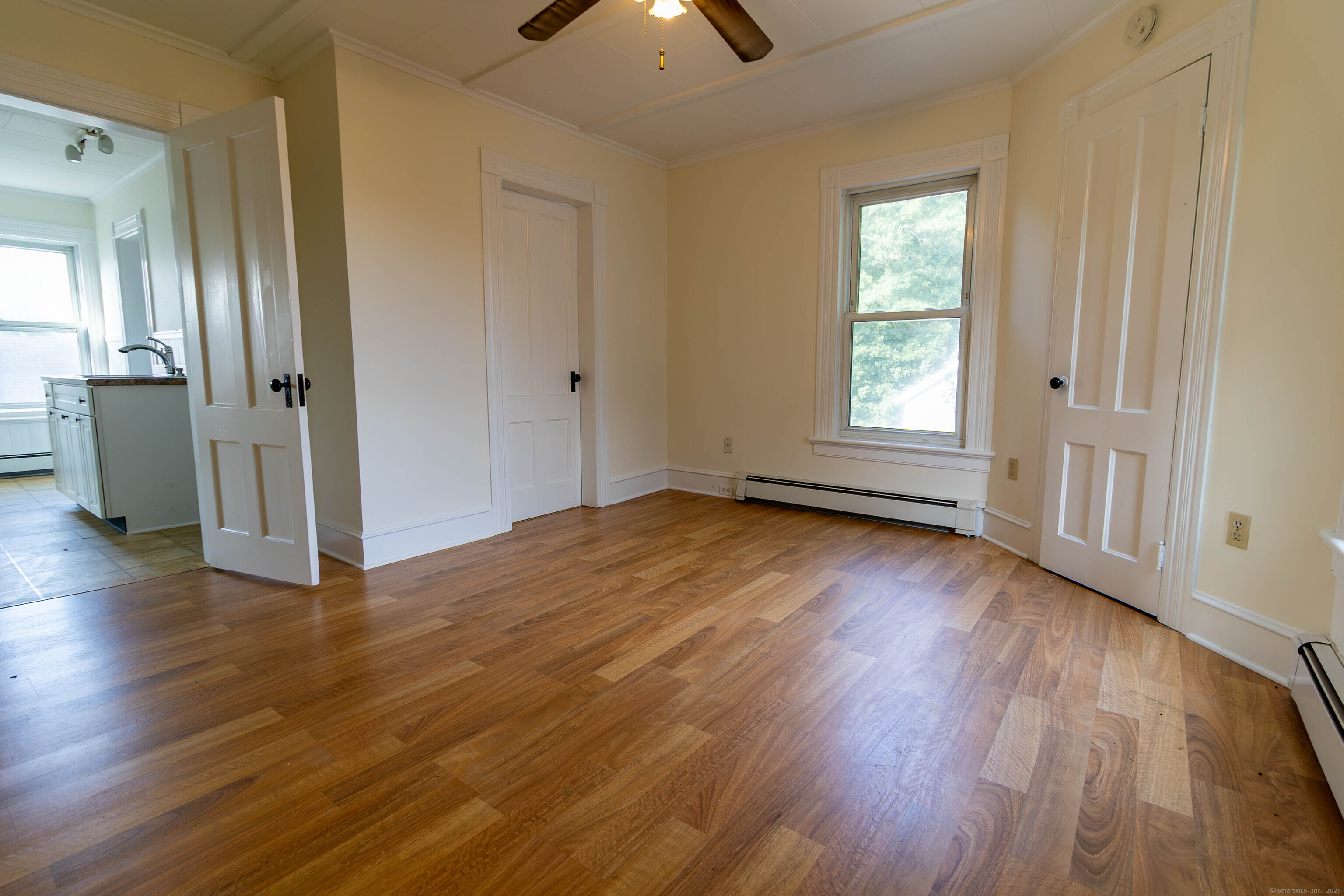 62 Lincoln Avenue Torrington, CT 06790 - Photo 3 of 15 an empty room with wooden floor and windows