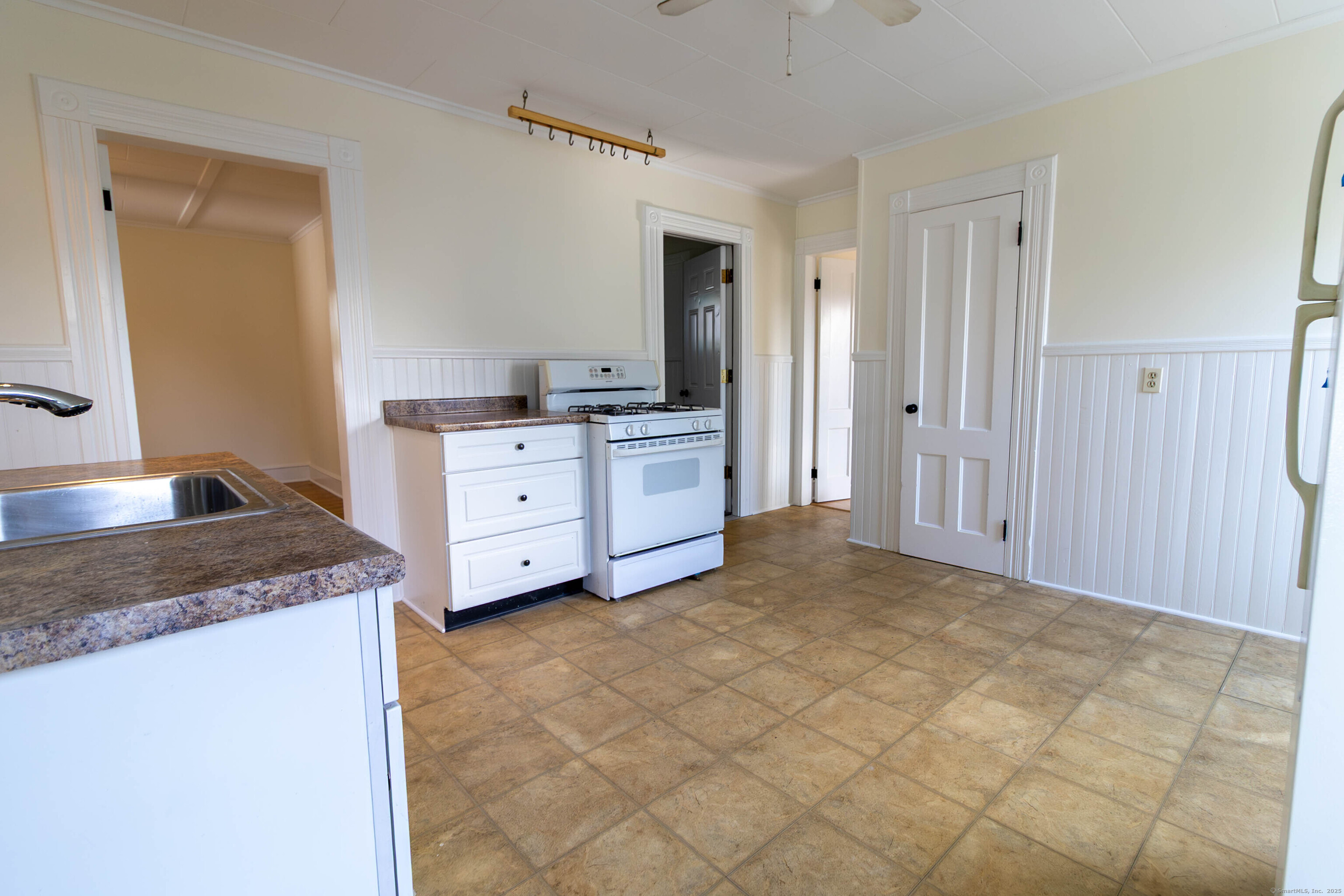 62 Lincoln Avenue Torrington, CT 06790 - Photo 6 of 15 a kitchen with a stove a sink and a refrigerator