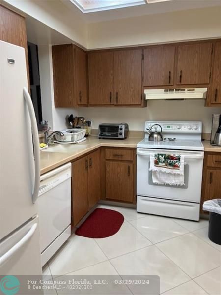 a kitchen with a stove sink and cabinets