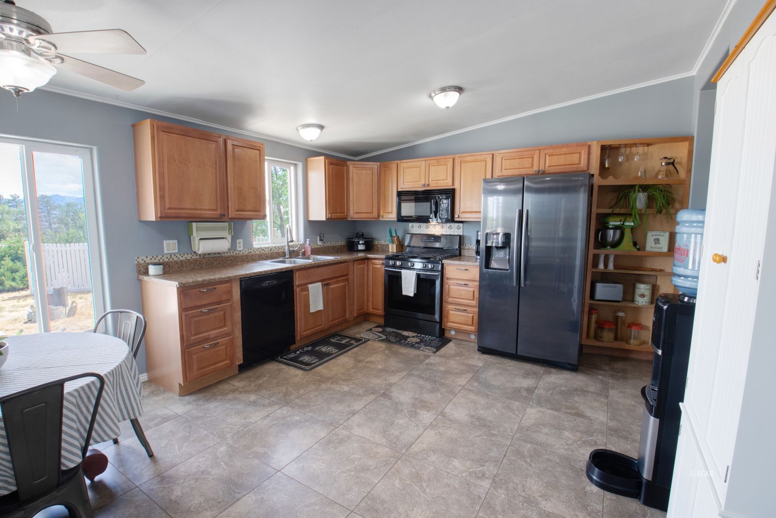 591 Spring Valley Parkway Spring Creek, NV 89815 - Photo 7 of 25 a kitchen with stainless steel appliances granite countertop a refrigerator stove top oven and sink