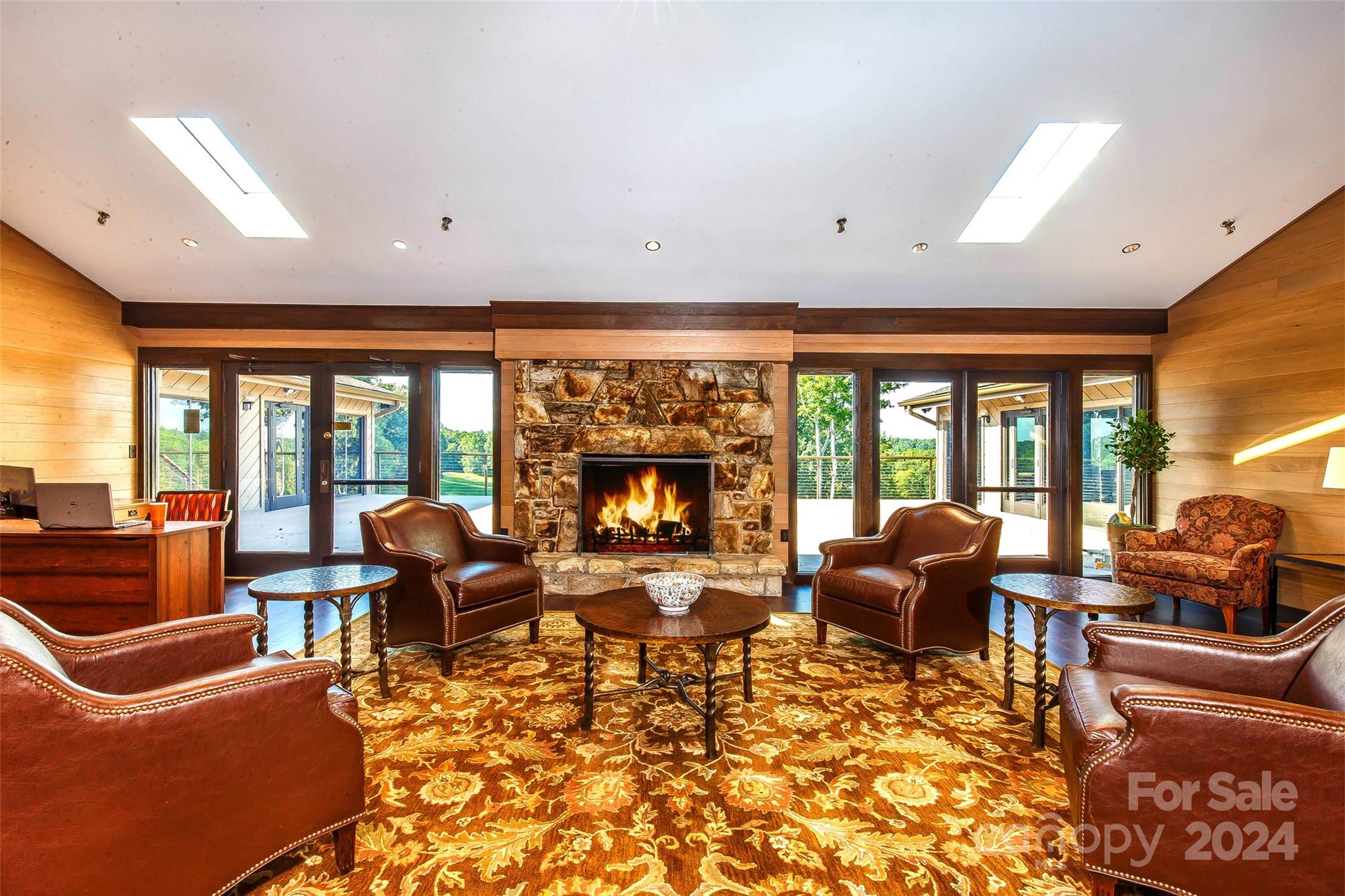 U22-l019 Cheulah Road, Unit 19/22 Brevard, NC 28712 - Photo 11 of 13 a living room with furniture large windows and a fireplace