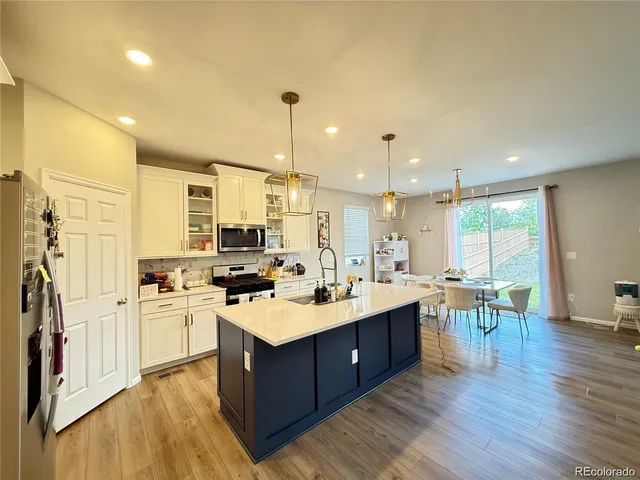 a large kitchen with a table and chairs