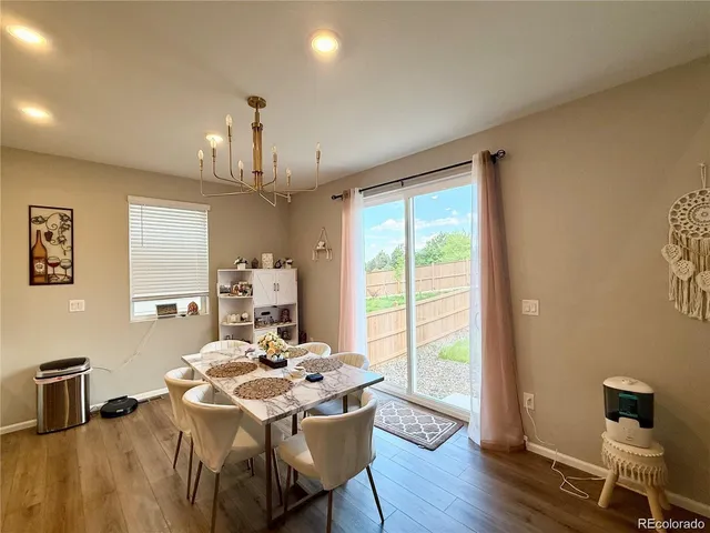 a living room with furniture fireplace and a large window