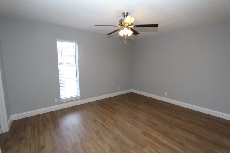 6509 Berkman Drive, Unit 114 Austin, TX 78723 - Photo 11 of 16 a view of wooden floor and a chandelier fan in a room