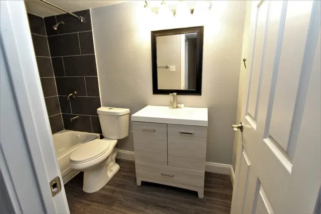 a bathroom with a toilet a sink and a mirror