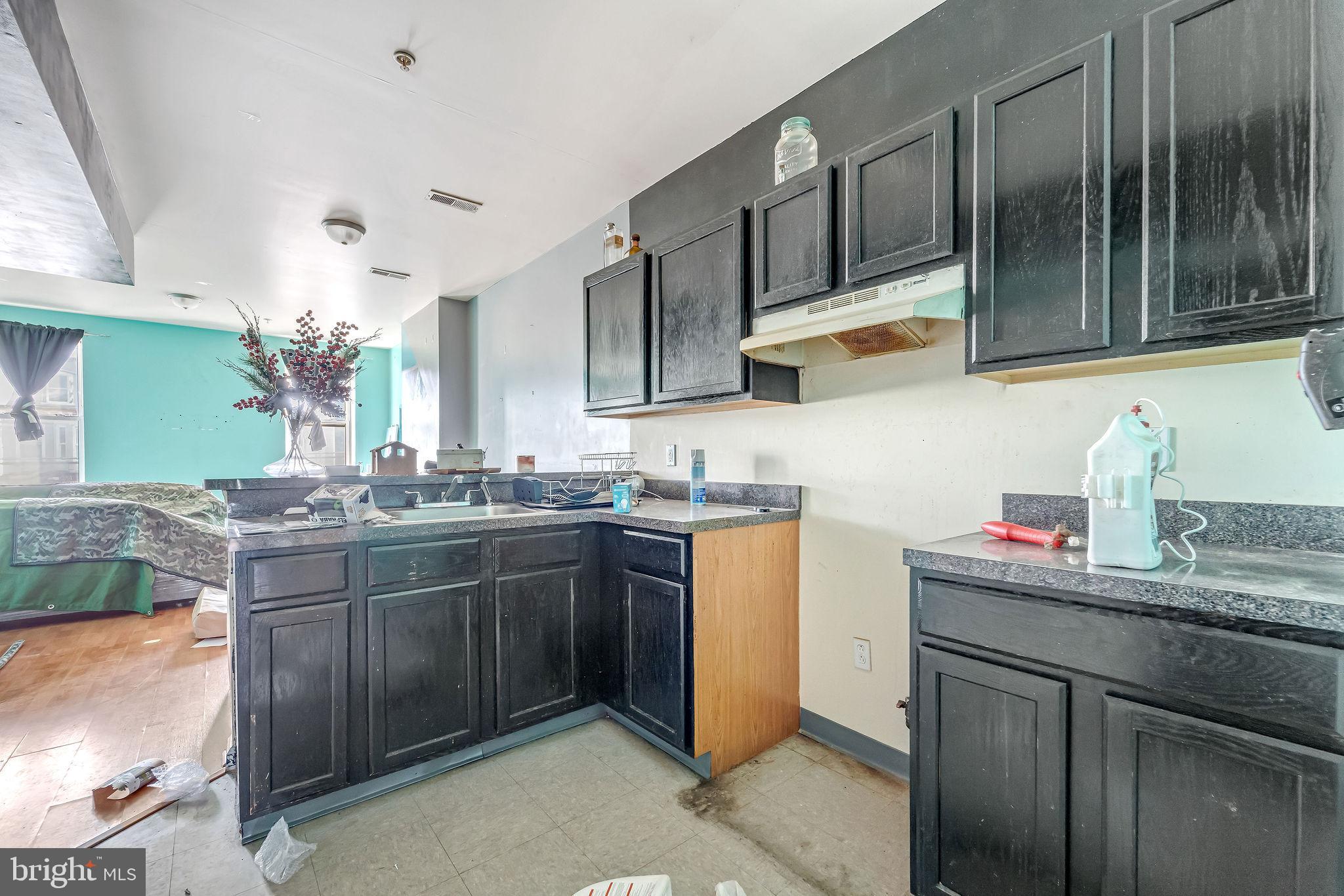 139 State Street Camden, NJ 08102 - Photo 23 of 29 a kitchen with stainless steel appliances granite countertop a sink dishwasher stove and cabinets