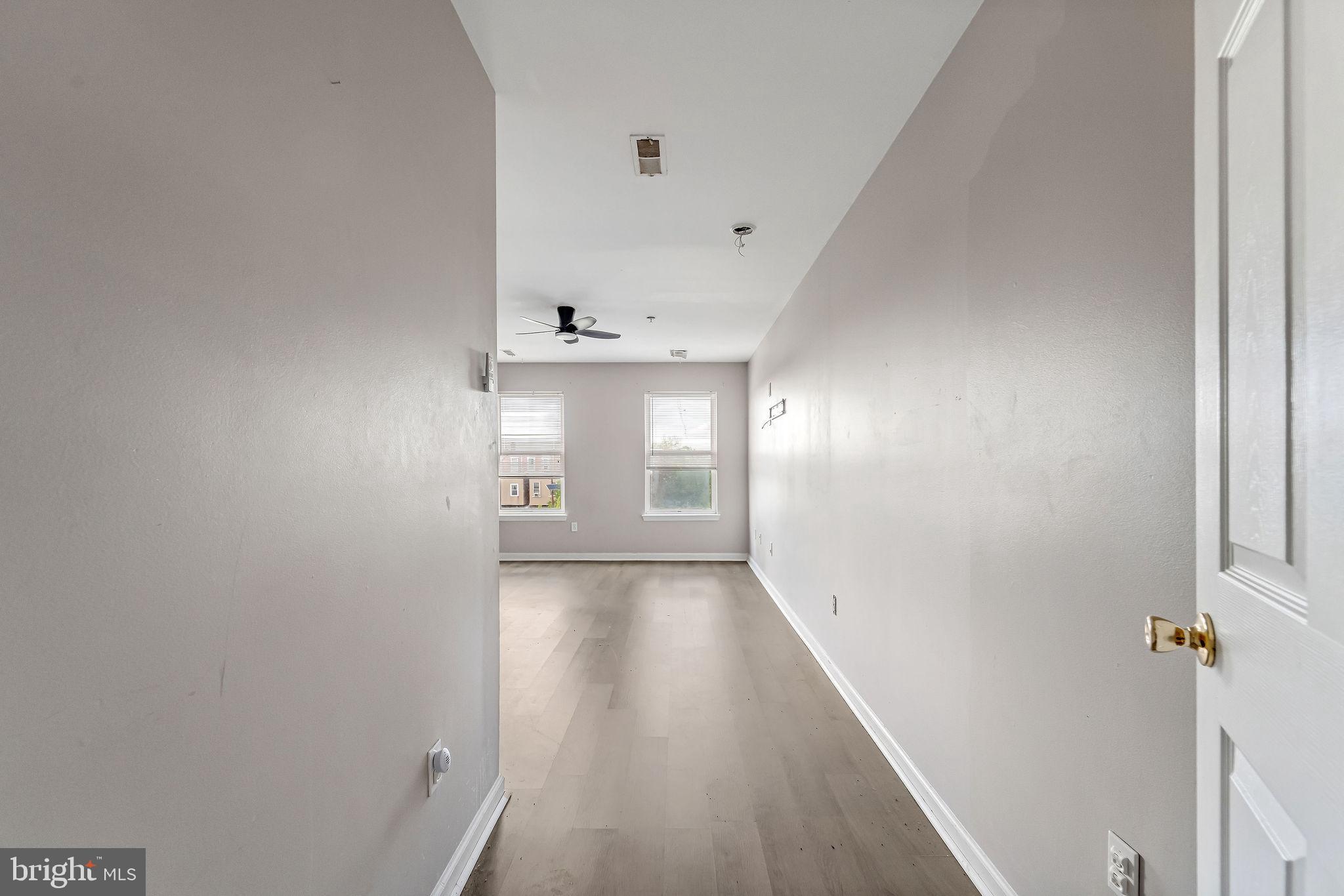 139 State Street Camden, NJ 08102 - Photo 3 of 29 a view of a hallway with wooden floor and a window