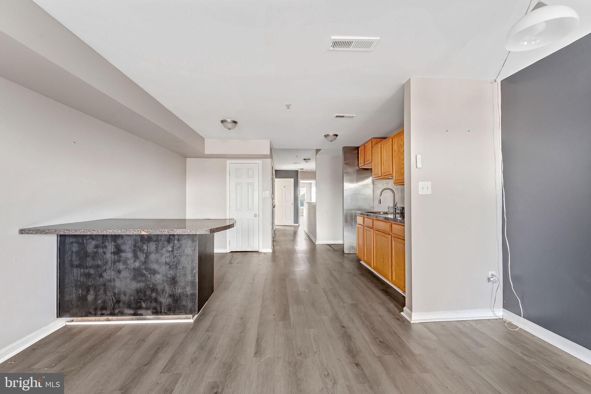 139 State Street Camden, NJ 08102 - Photo 5 of 29 a view of a hallway with wooden floor and a refrigerator