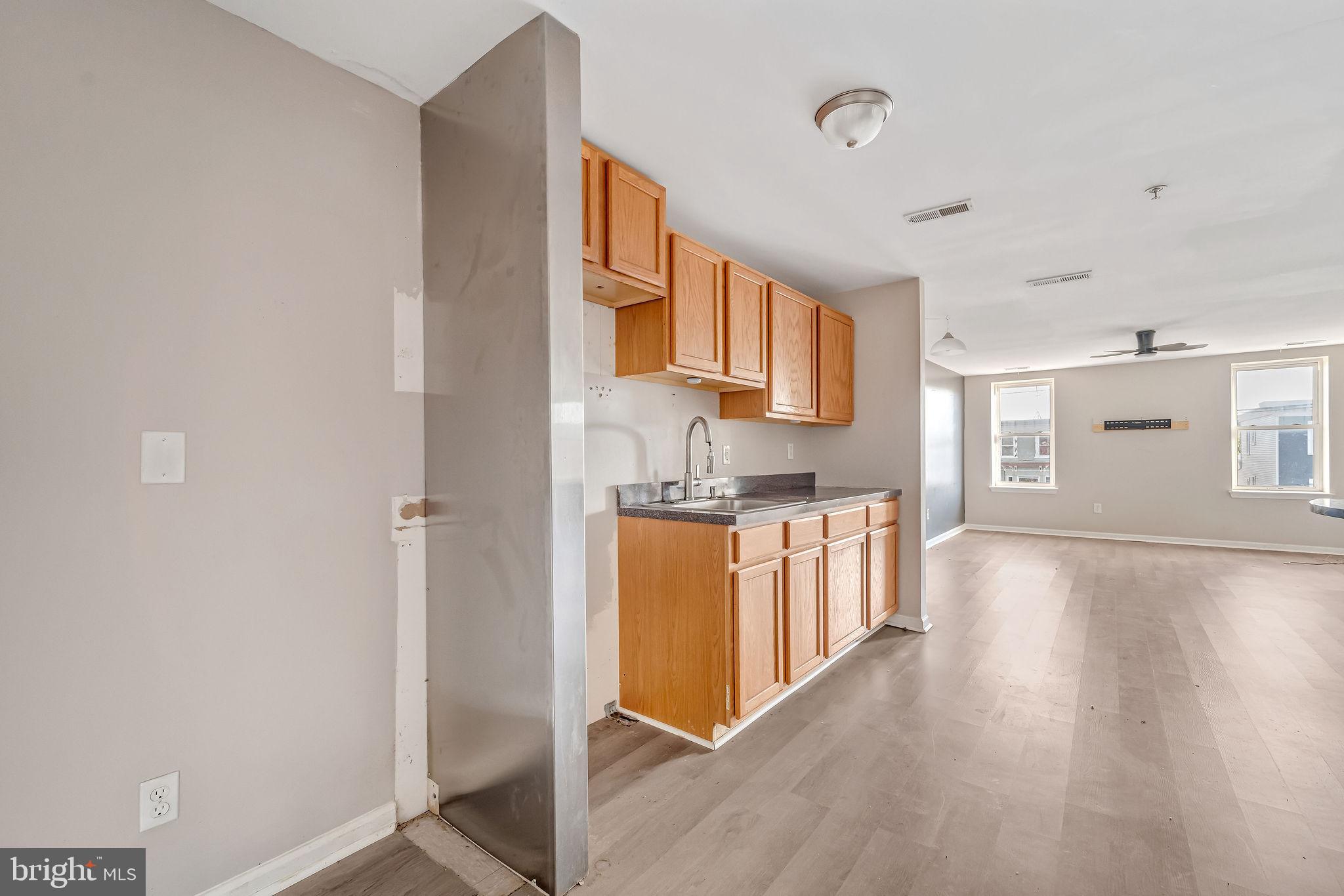 139 State Street Camden, NJ 08102 - Photo 7 of 29 a kitchen with stainless steel appliances granite countertop a stove a sink and a refrigerator with wooden floor