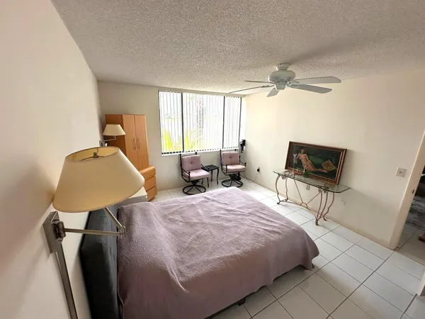 a bedroom with furniture and a window