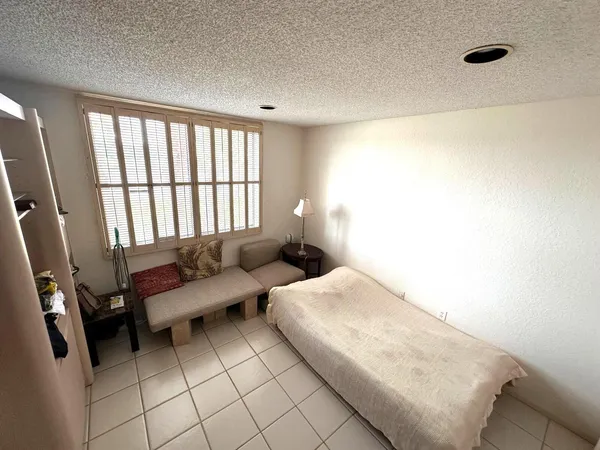 a bedroom with furniture and a window