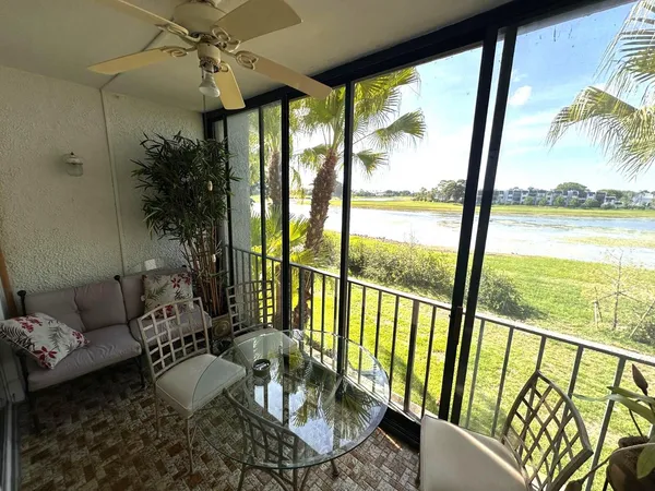 a living room with large windows and furniture