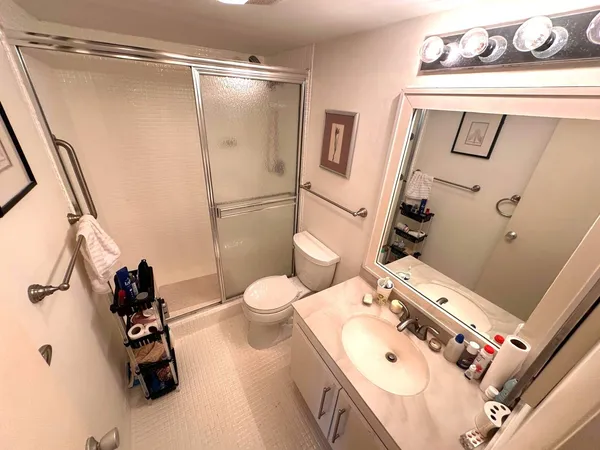 a bathroom with a sink mirror vanity and toilet