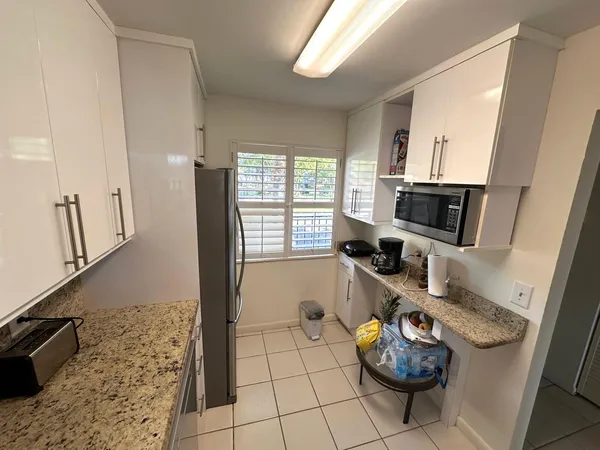 a living room with furniture a flat screen tv and a window