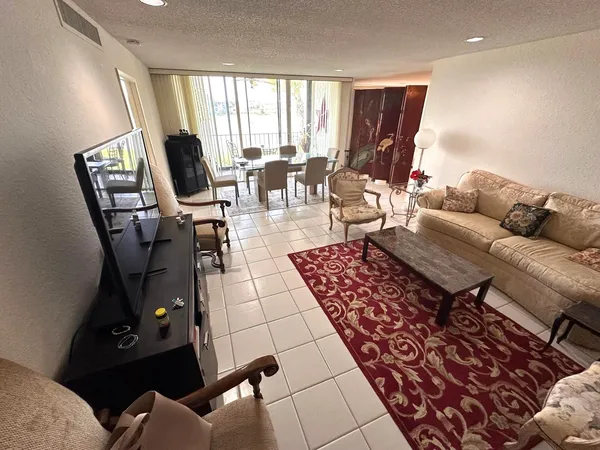 a living room with furniture and a floor to ceiling window