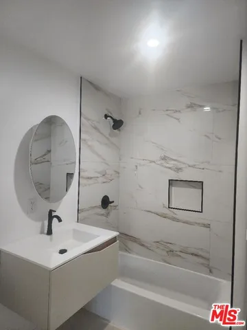 a bathroom with a sink and mirror