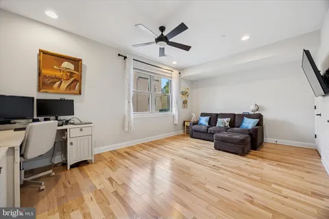 a living room with furniture and a wooden floor