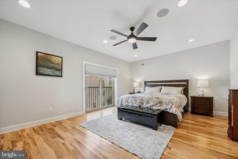 a bedroom with a large bed and a chandelier