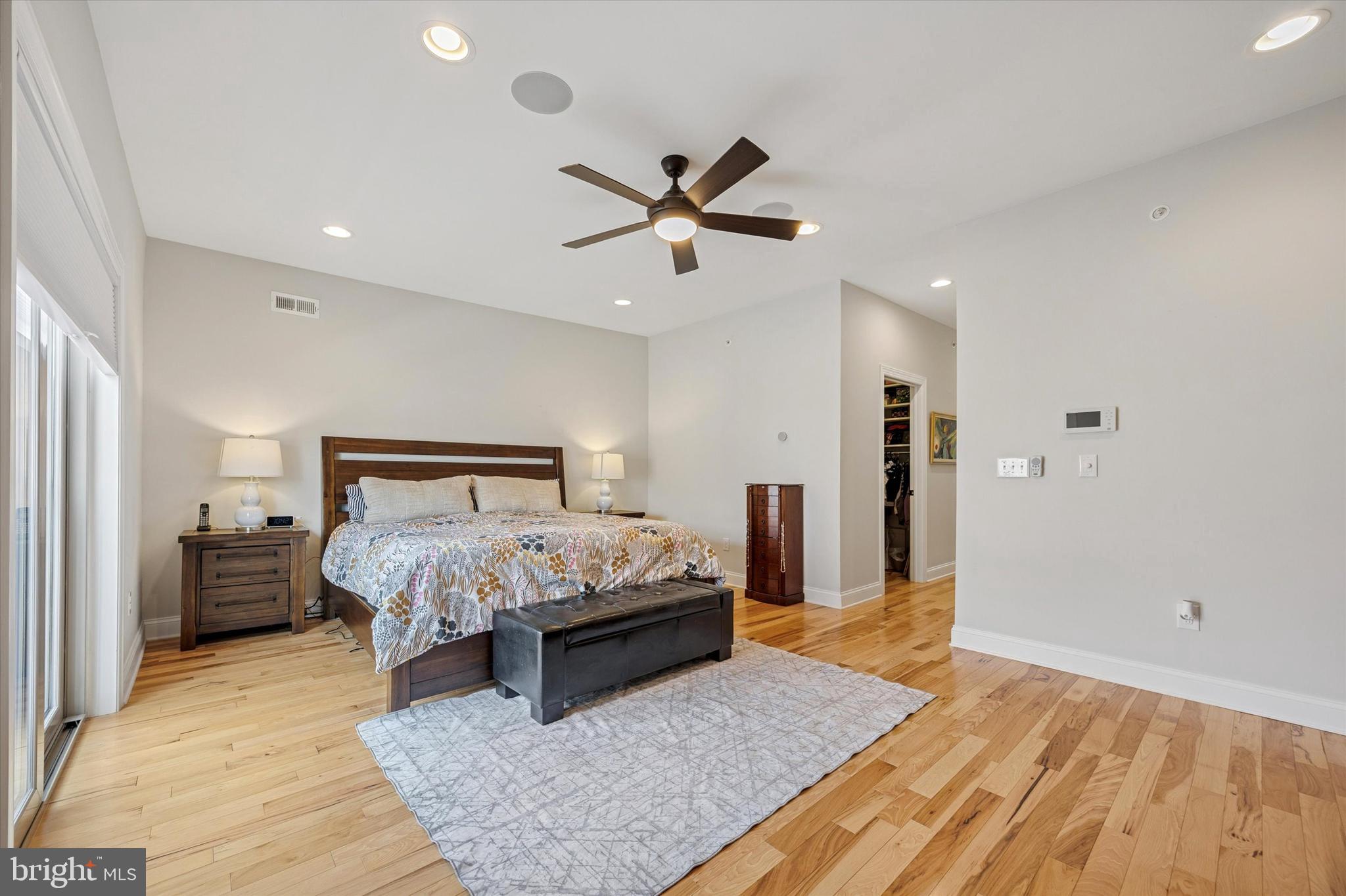 152 Carson Street Philadelphia, PA 19127 - Photo 16 of 33 a spacious bedroom with a bed and a chandelier