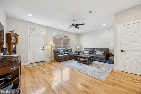 a living room with furniture and a wooden floor