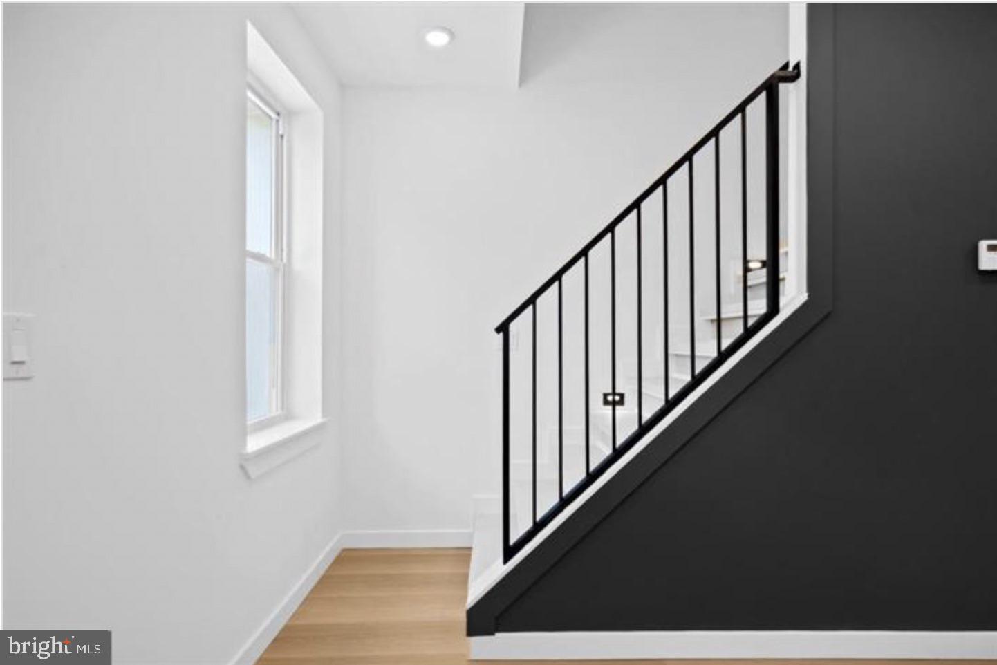 2215 Mutter Street Philadelphia, PA 19133 - Photo 15 of 21 a view of staircase with lots of frames on wall and a window