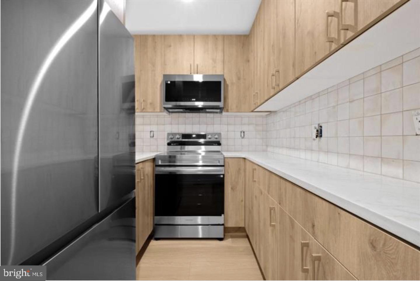 2215 Mutter Street Philadelphia, PA 19133 - Photo 7 of 21 a kitchen with stainless steel appliances a stove microwave and refrigerator