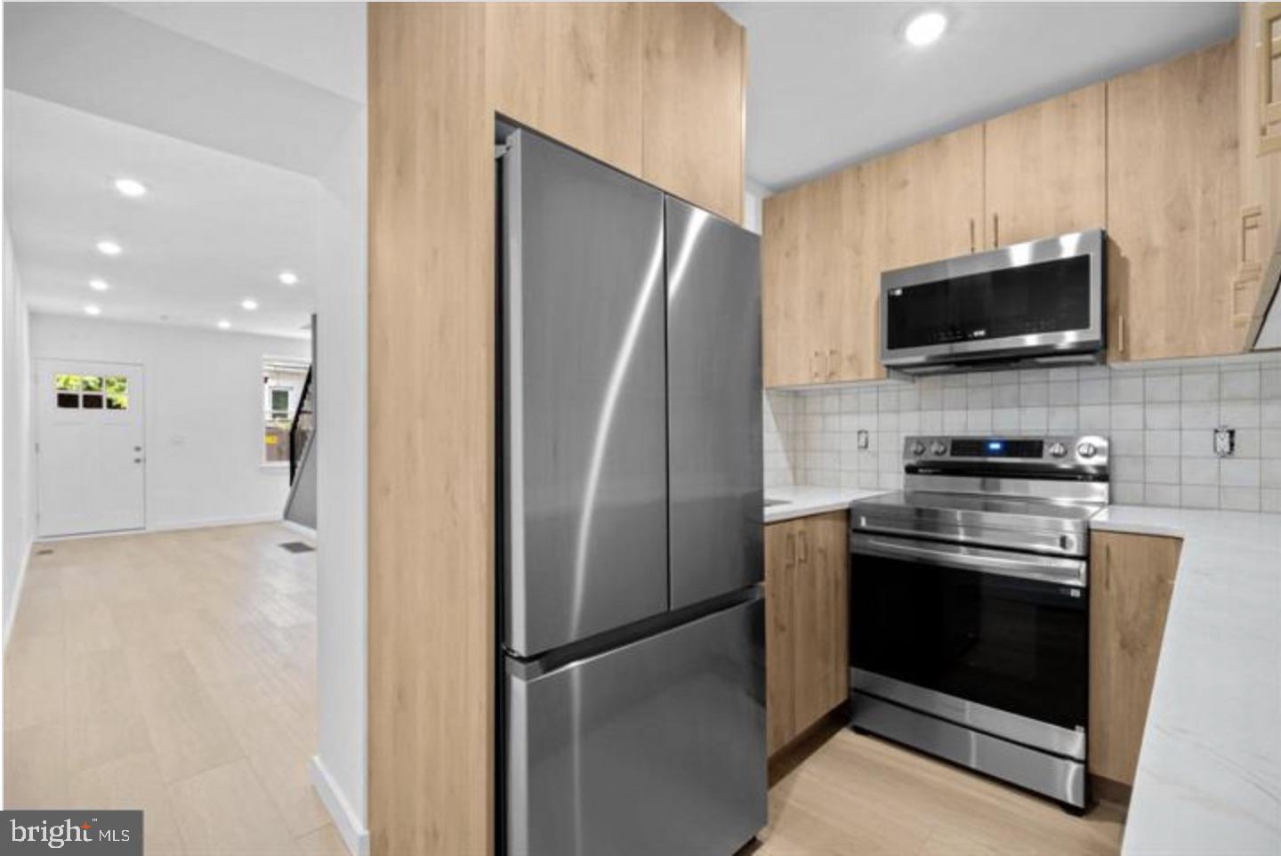 2215 Mutter Street Philadelphia, PA 19133 - Photo 10 of 21 a kitchen with stainless steel appliances a refrigerator stove and microwave