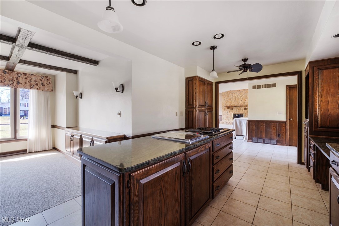 7059 Stewart Sharon Road Hubbard, OH 44425 - Photo 21 of 49 Kitchen with dark countertops, visible vents, a center island, beam ceiling, and a ceiling fan