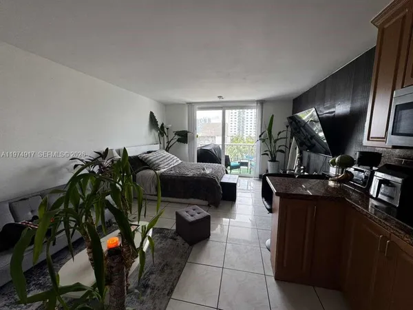a bedroom with a bed and a large window