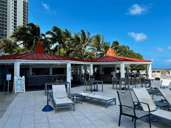 a view of a swimming pool with outdoor seating